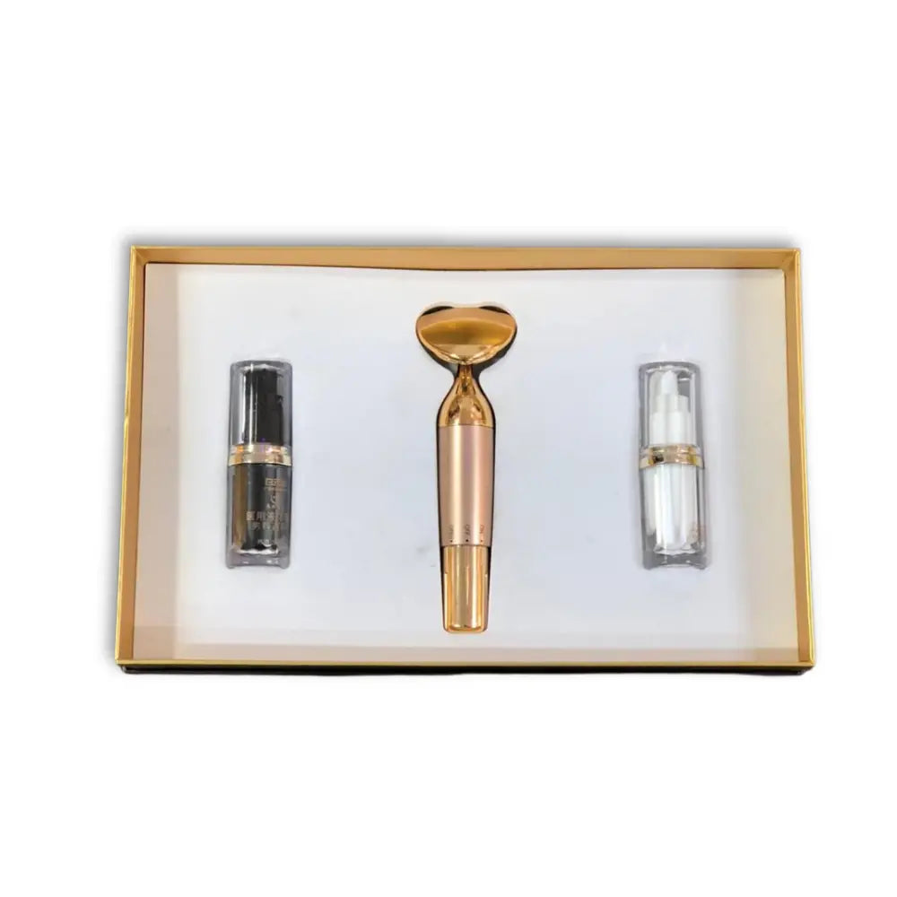 Skincare gift set with two serums and a roller device in a gold box 