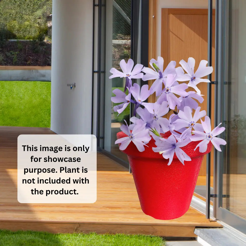 Red pot with purple flowers on a wooden deck