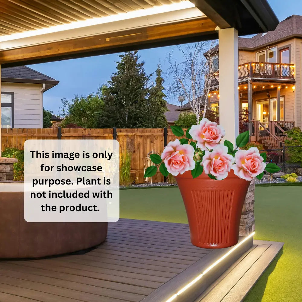 Potted plant on a wooden deck with a house in the background