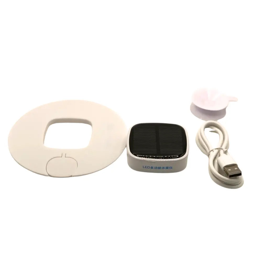 Sterilizer with Solar Charger, white disc, and USB cable on a white background