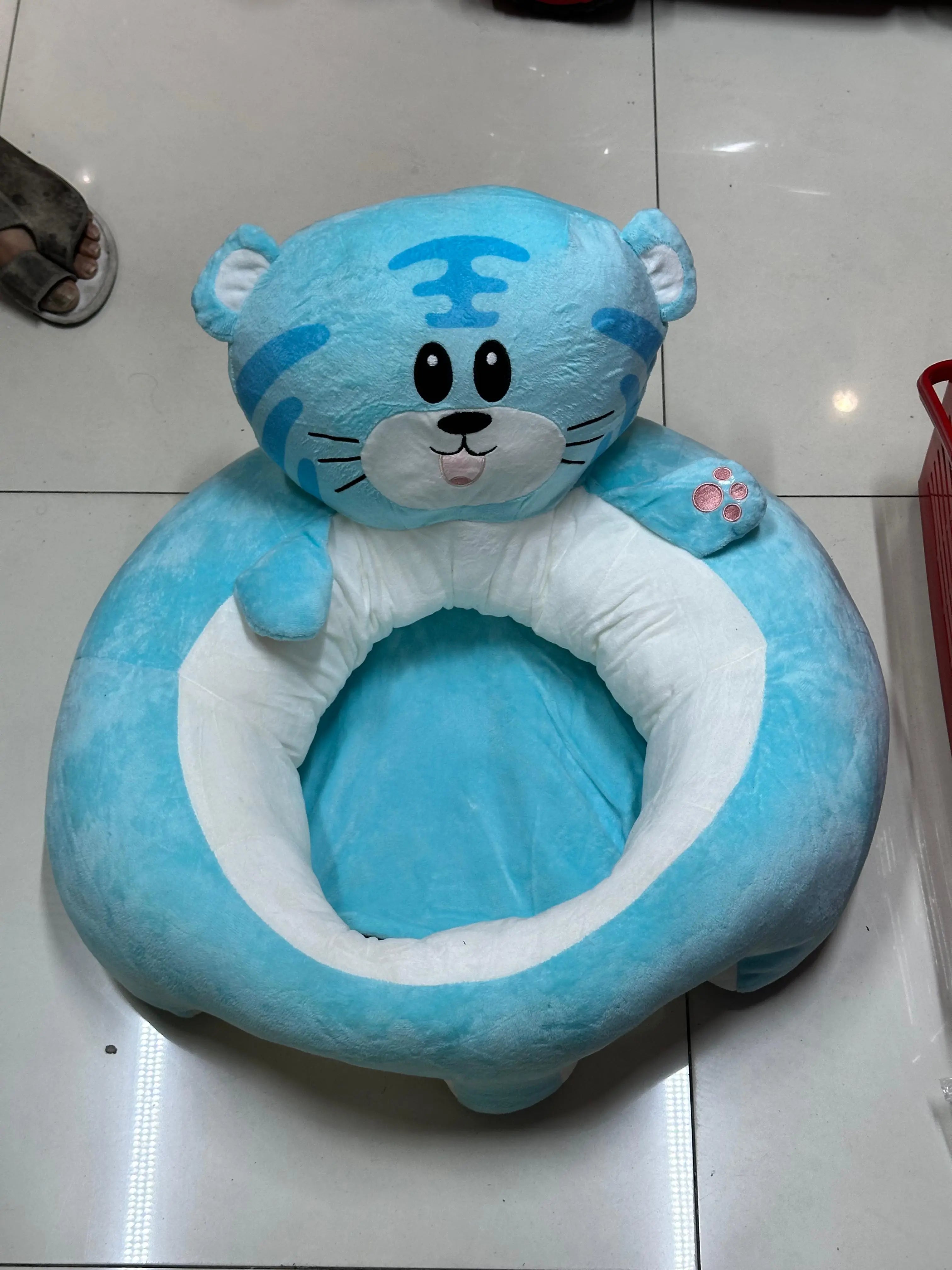 Blue baby seat with cartoon face design