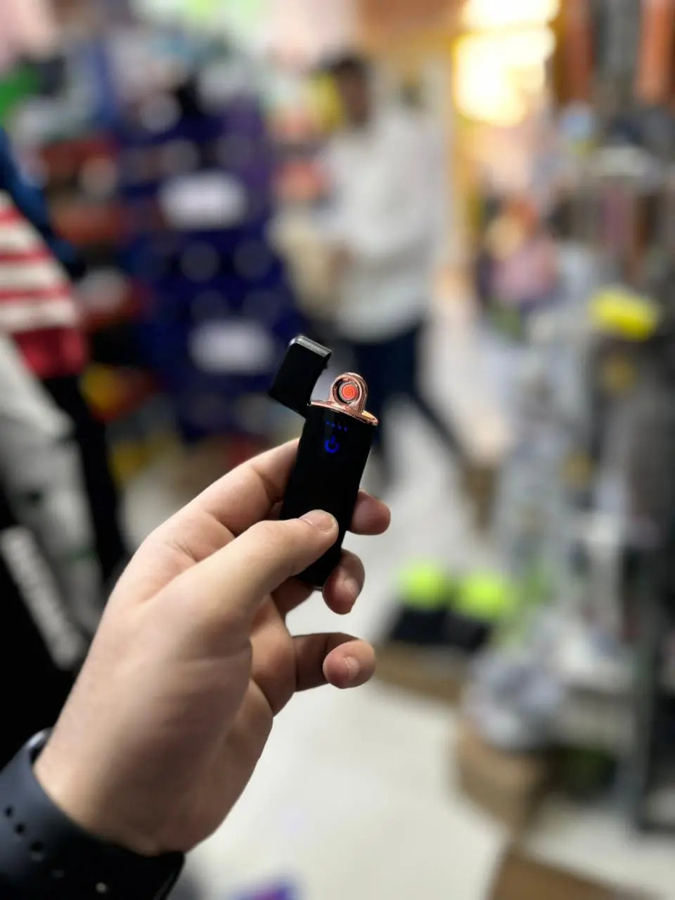 Hand holding a small electric lighter