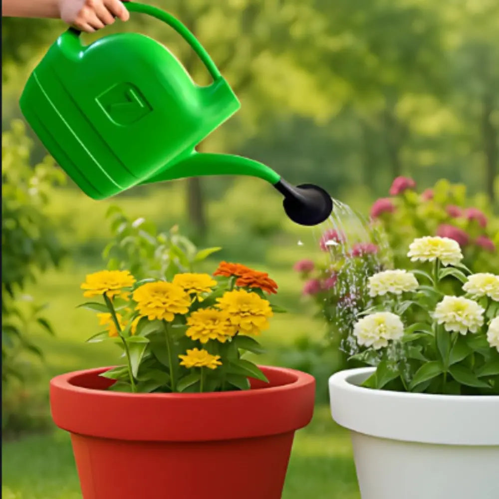Person watering flowers in pots with a green watering can